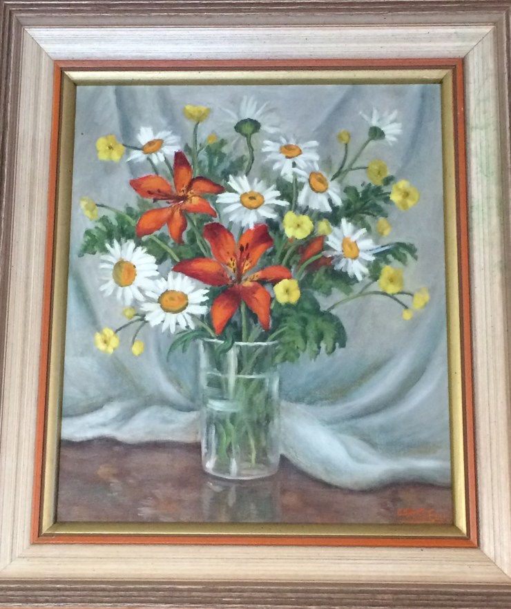 A painting depicting vase of buttercups, daisies, tiger lilies and ferns backdrop by drapery. The painting is signed Kae Heart Ellis.